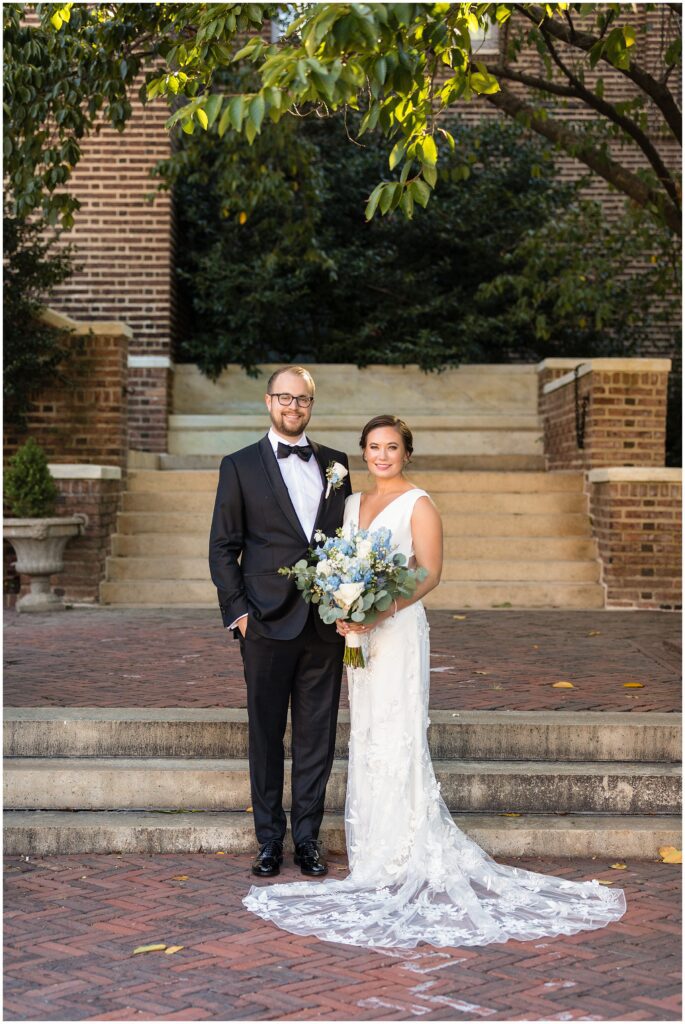 Newlyweds, and Bride holds her blue and white bouquet