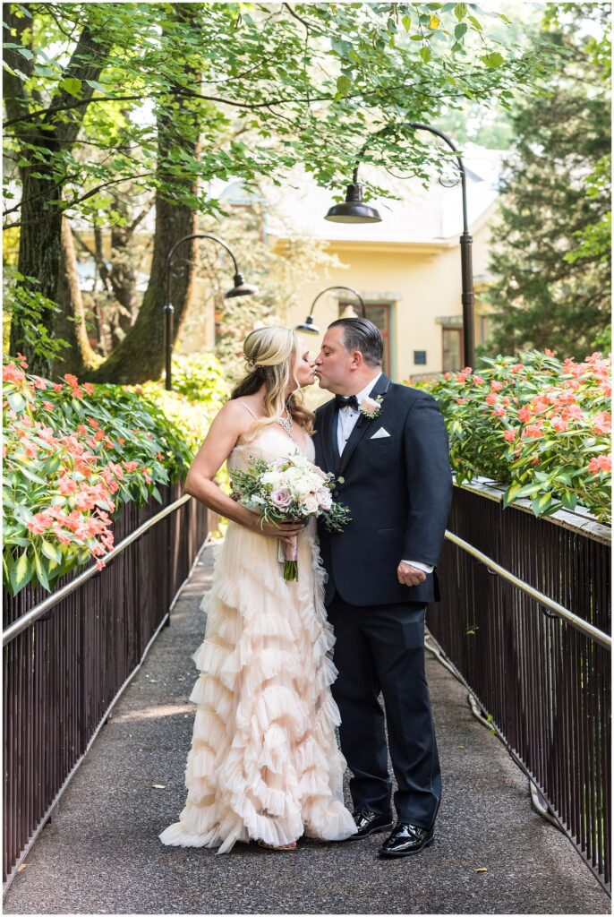 Bride and Groom kiss on bridge after their first look