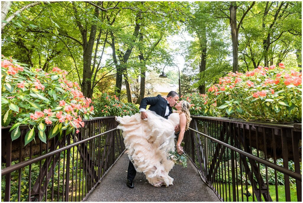Groom dips his bride for a kiss