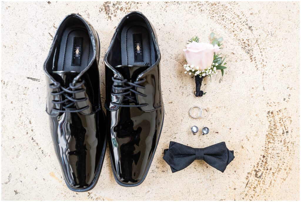 Groom Details - black shoes, white boutonniere, cufflinks, and bow tie