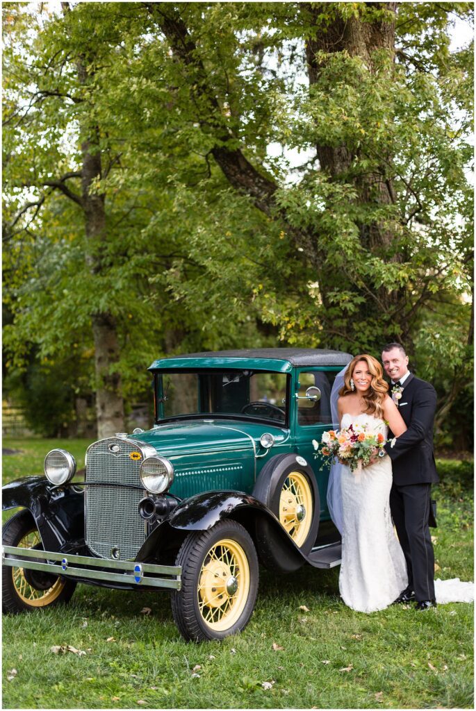 couple with vintage car at Rose Bank Winery