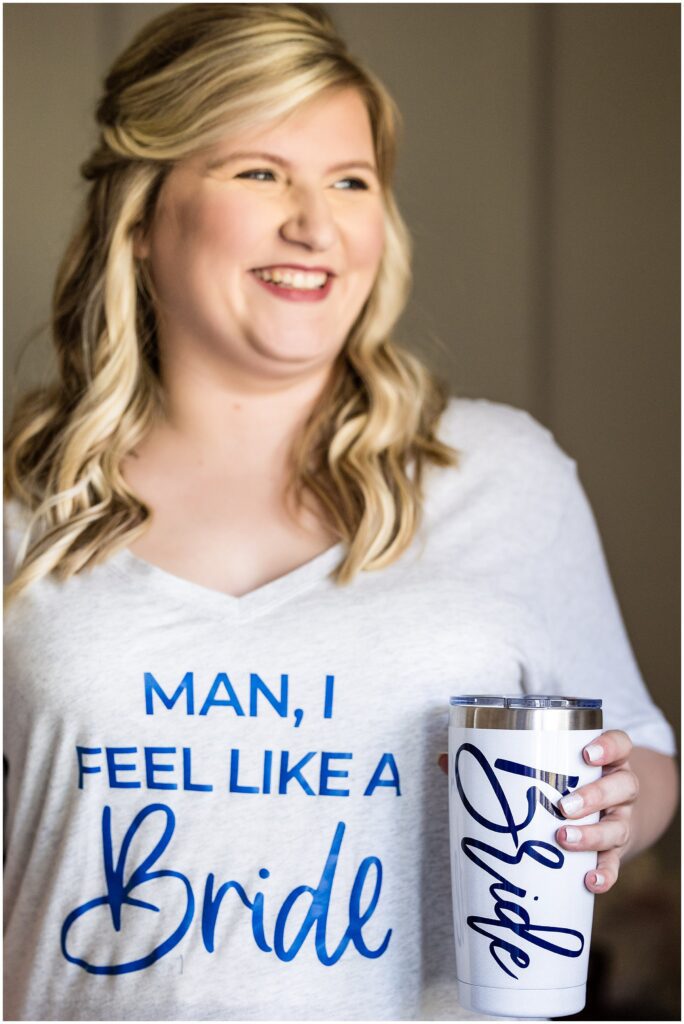 Bride on the morning of her wedding with "Bride" cup and shirt that says "Man, I feel like a Bride"