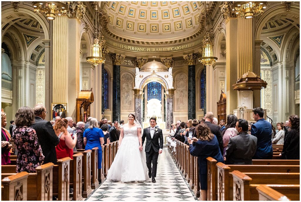 Newlyweds exit their wedding ceremony at Cathedral Basilica of Saints Peter and Paul