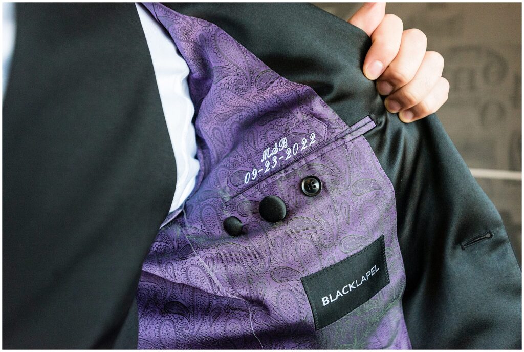Tuxedo jacket has purple fabric liner with initials and wedding date embroidered above inside pocket