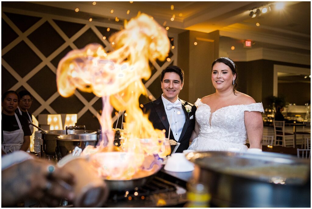 Couple observes the flambe flames at their wedding reception 