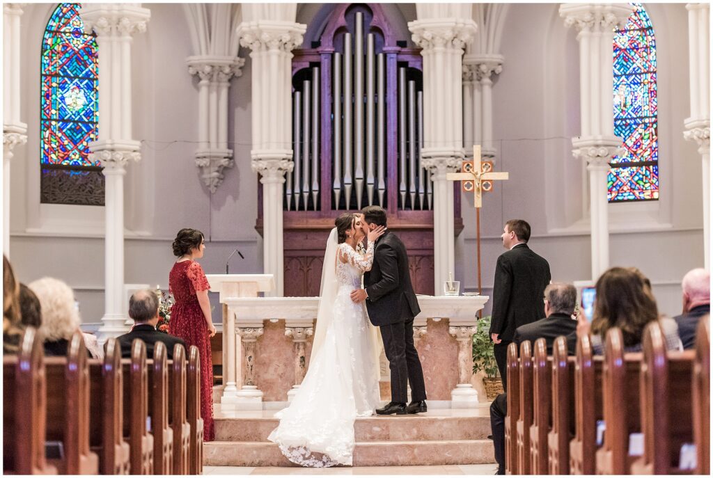 couple's first kiss during their wedding ceremony at Villanova Chapel