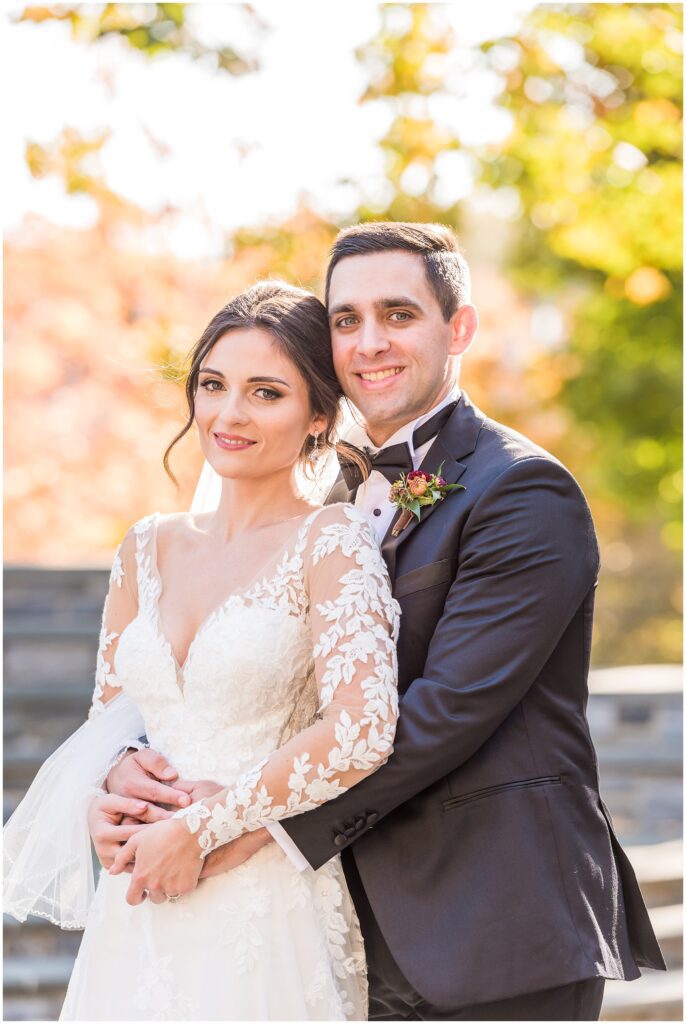 Newlyweds pose for a portrait after their fall wedding