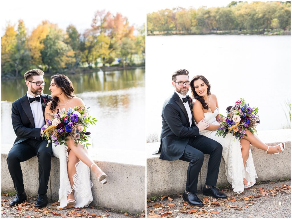 Bride and Groom sit near water for portraits on their fall wedding day