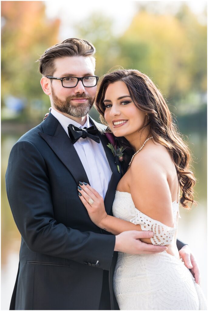 Groom in black tux with Bride in white lace detail dress