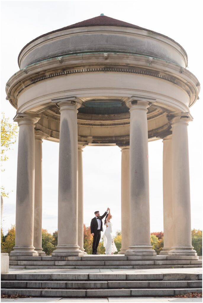 Groom twirls Bride under the Pavilion in FDR Park