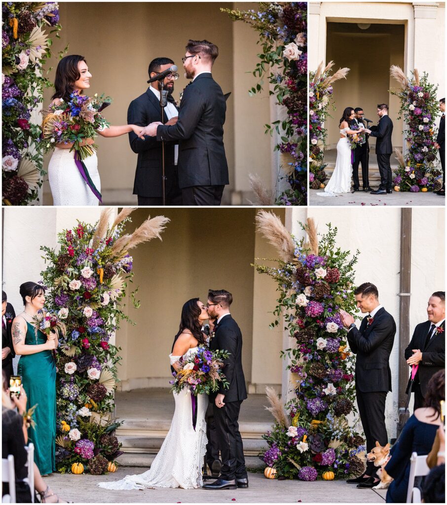Ring exchange and first kiss, while surrounded by dramatic jewel-toned florals