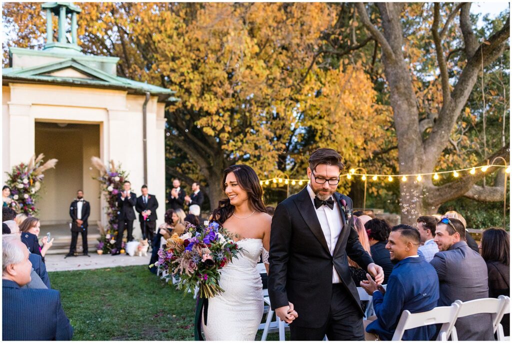 newlyweds exit their fall wedding ceremony at American Swedish History Museum