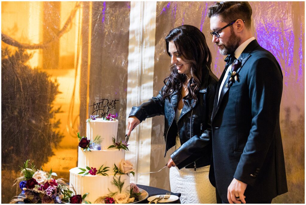Bride and groom cut their 3-tier wedding cake