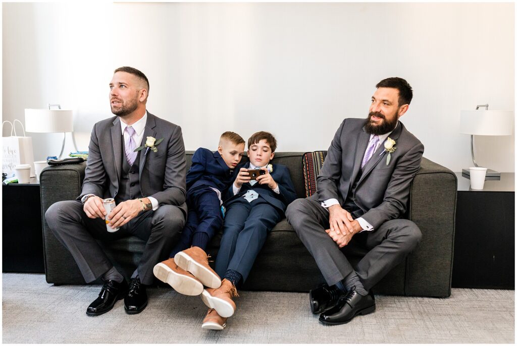 Groom's wedding party relaxes while getting ready