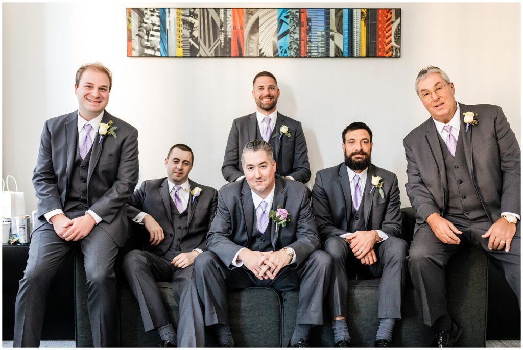 Groom and his wedding party, all in gray suits