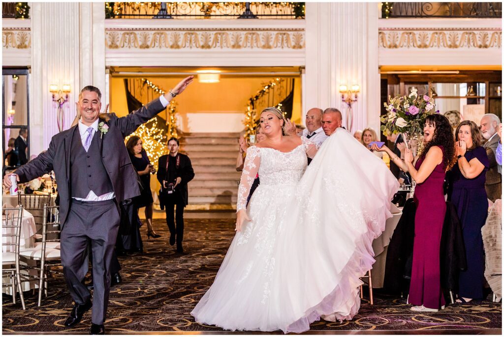 Newlyweds have fun entering their wedding reception