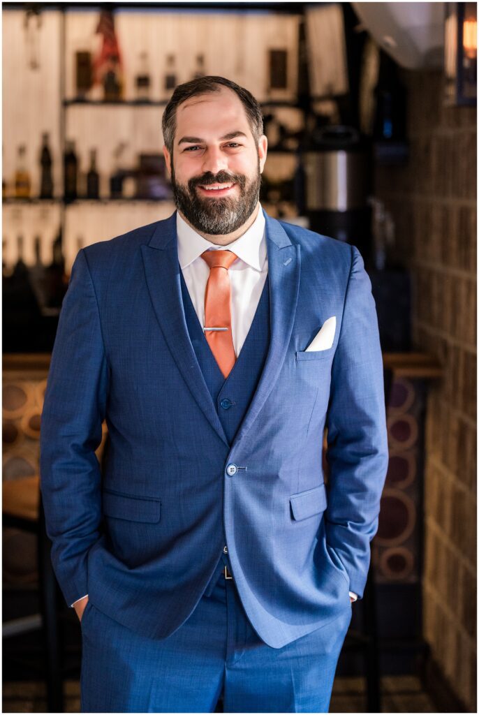 portrait of groom in navy suit