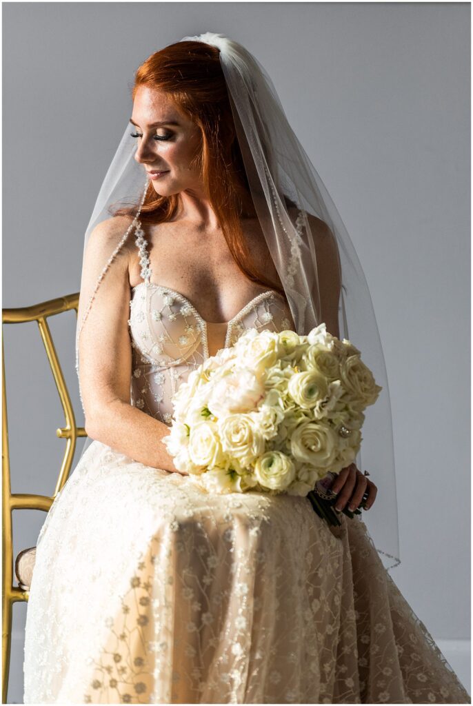 Bride in champagne dress with white and cream bridal bouquet 