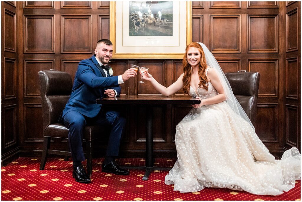 Bride and groom share a toast after their wedding