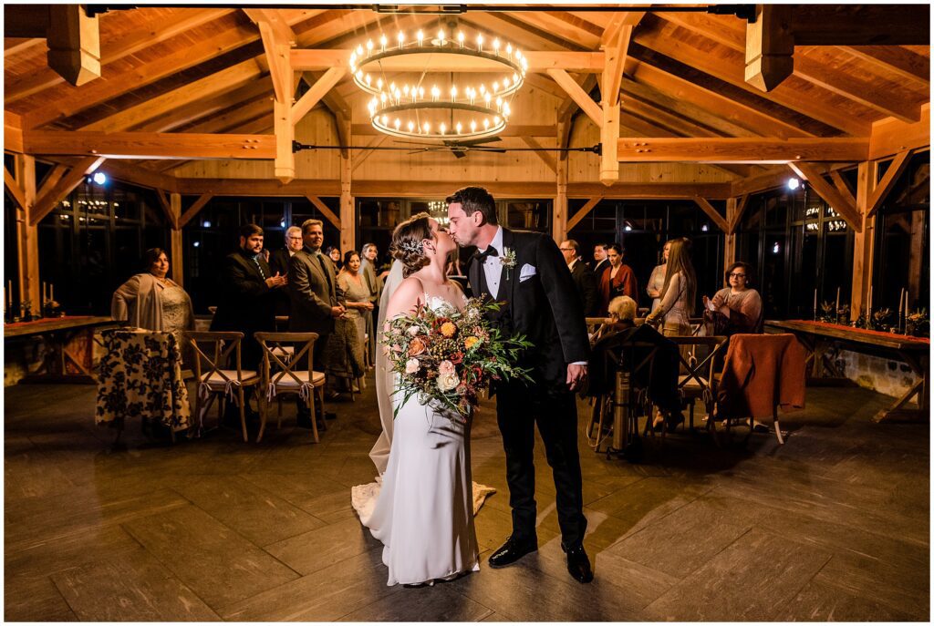 Newlyweds kiss as they process out of their wedding ceremony