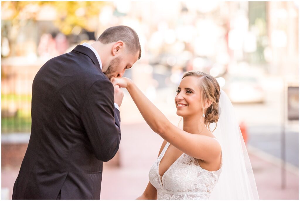 Groom kisses his Bride's hand