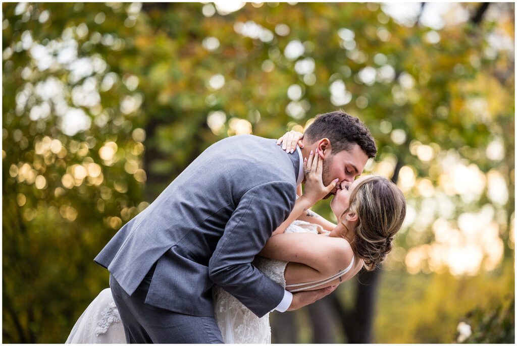 groom dips his bride for a kiss