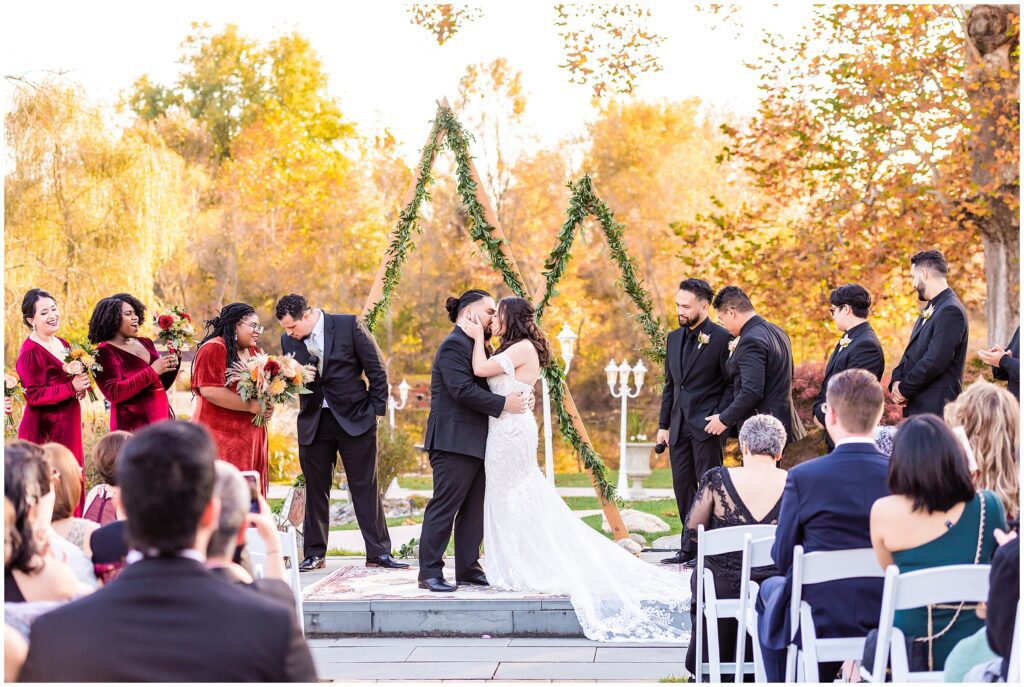 first kiss during fall wedding ceremony