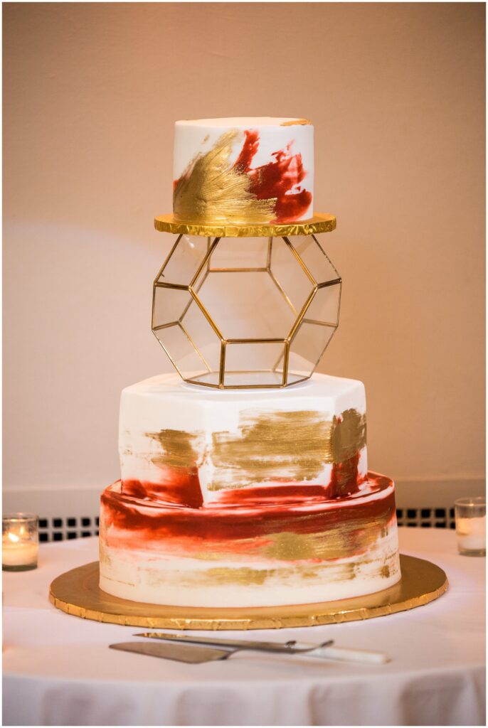 fall wedding cake with gold and burgundy, and clear geometric tier detail