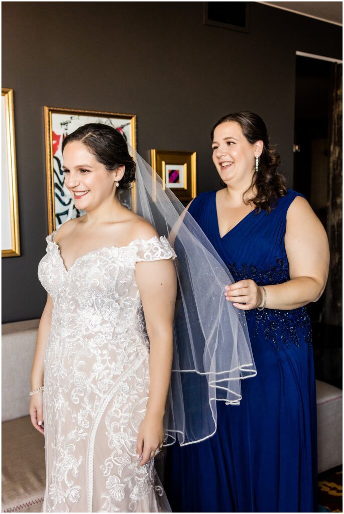 Bride's sister adjusts the veil