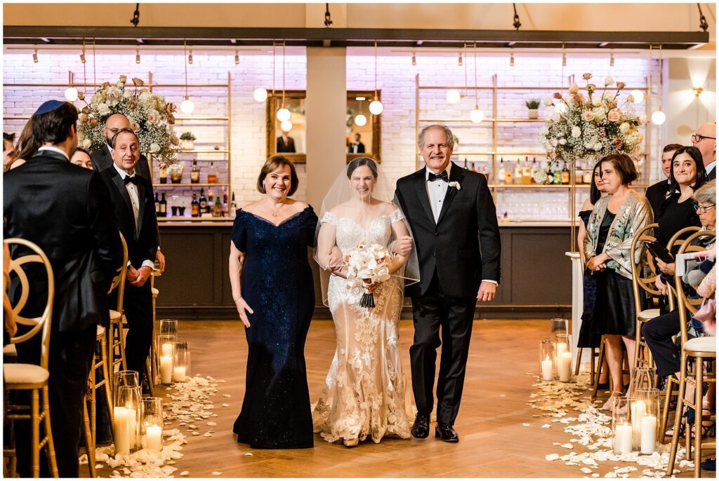 Bride is escorted by her parents