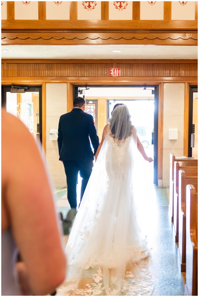 Bride and groom walking out of church after traditional wedding ceremony at St. Cecilia | Ashley Gerrity Photography